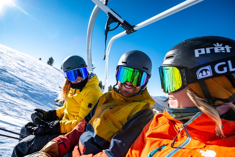 skiers on a chairlift in Vail, CO